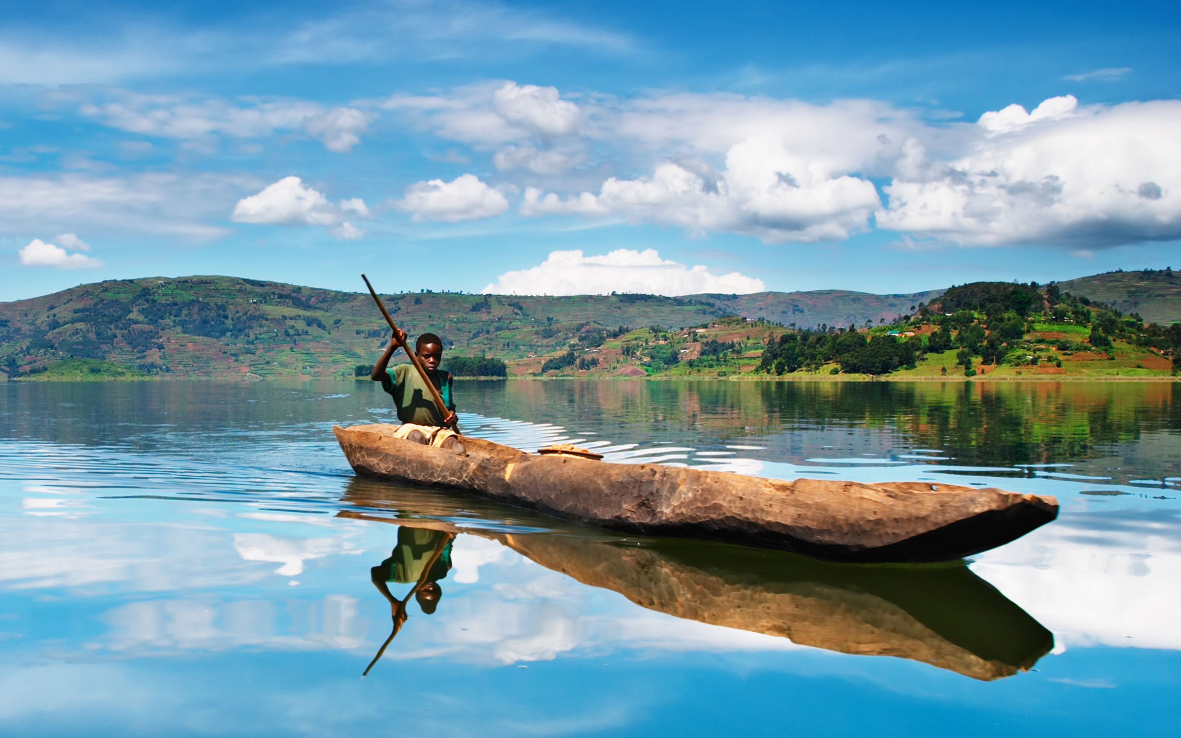 boy canoeing - Jinga, Uganda - Ker & Downey